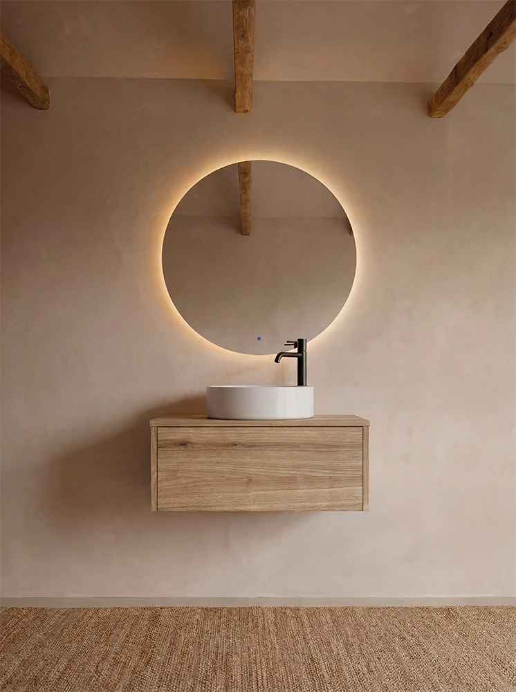 Mueble suspendido con lavabo sobre encimera y espejo circular
